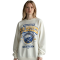 Person wearing a cream-colored sweatshirt with 'Buffalo Sabres' logo on a plain background