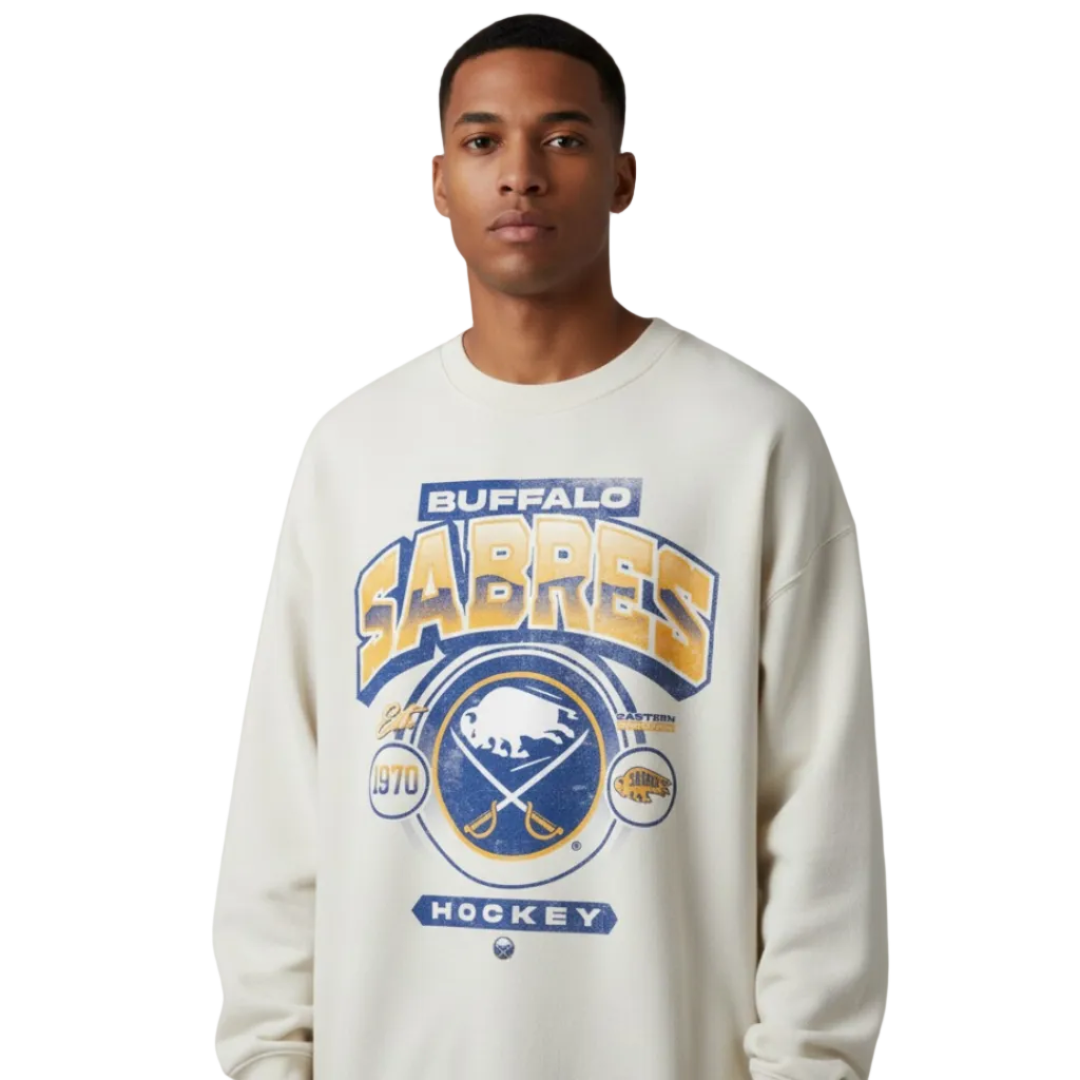 Person wearing a Buffalo Sabres sweatshirt against a gray background