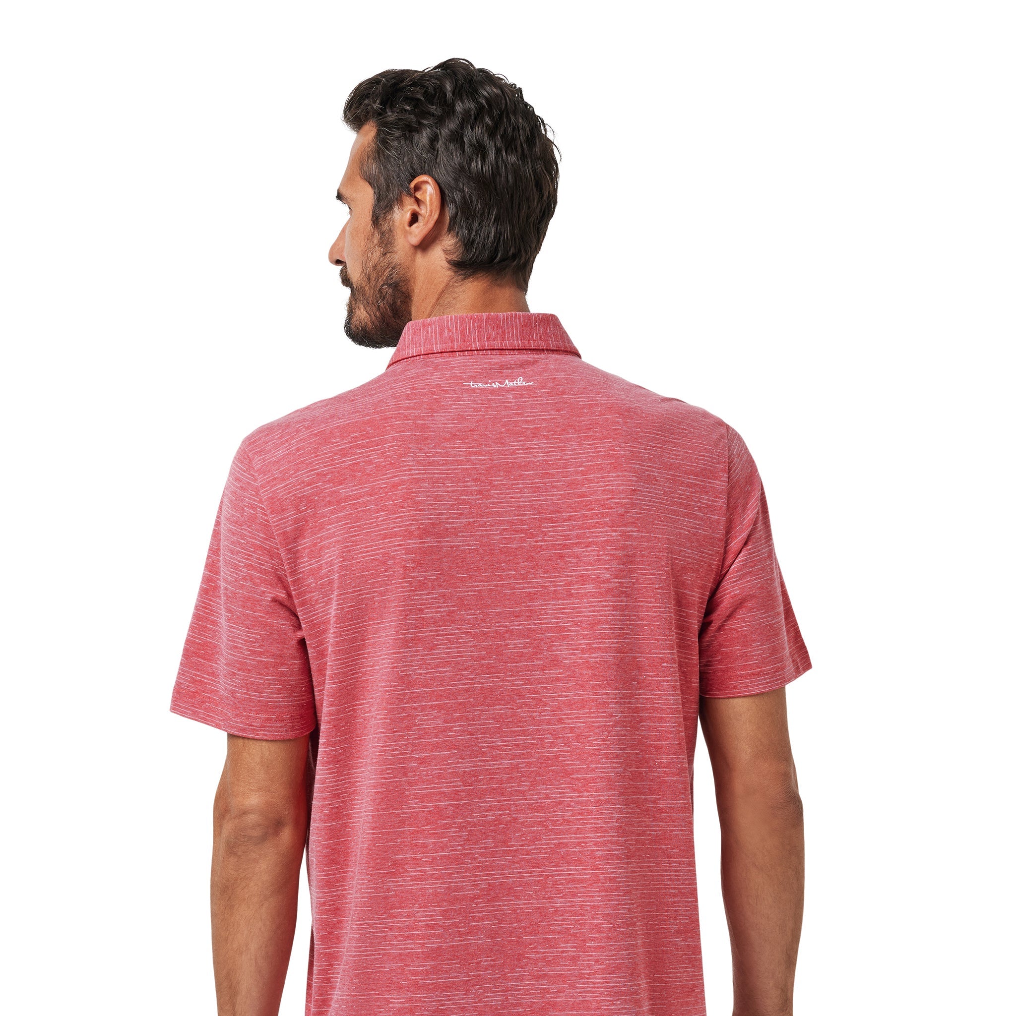 A man viewed from the back wearing a heathered coral-red short-sleeve polo shirt and dark pants against a plain white background.