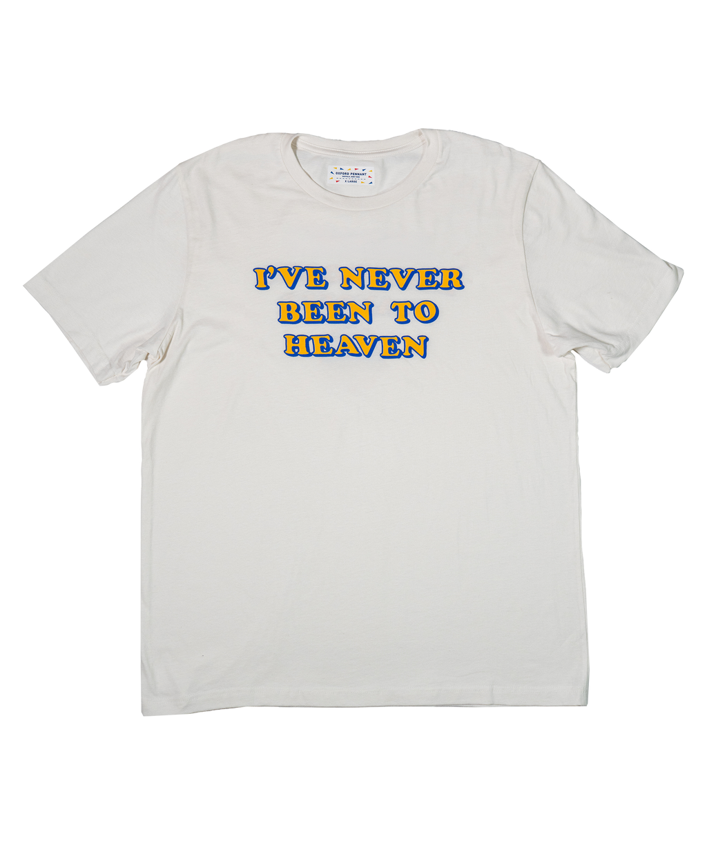White t-shirt with colorful text 'I'VE NEVER BEEN TO HEAVEN' on a white background