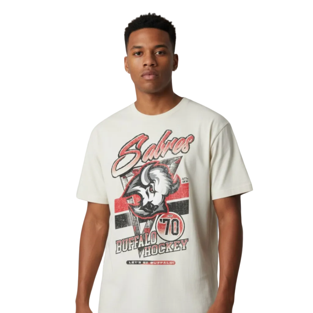 Man wearing a white t-shirt with a graphic design on a gray background