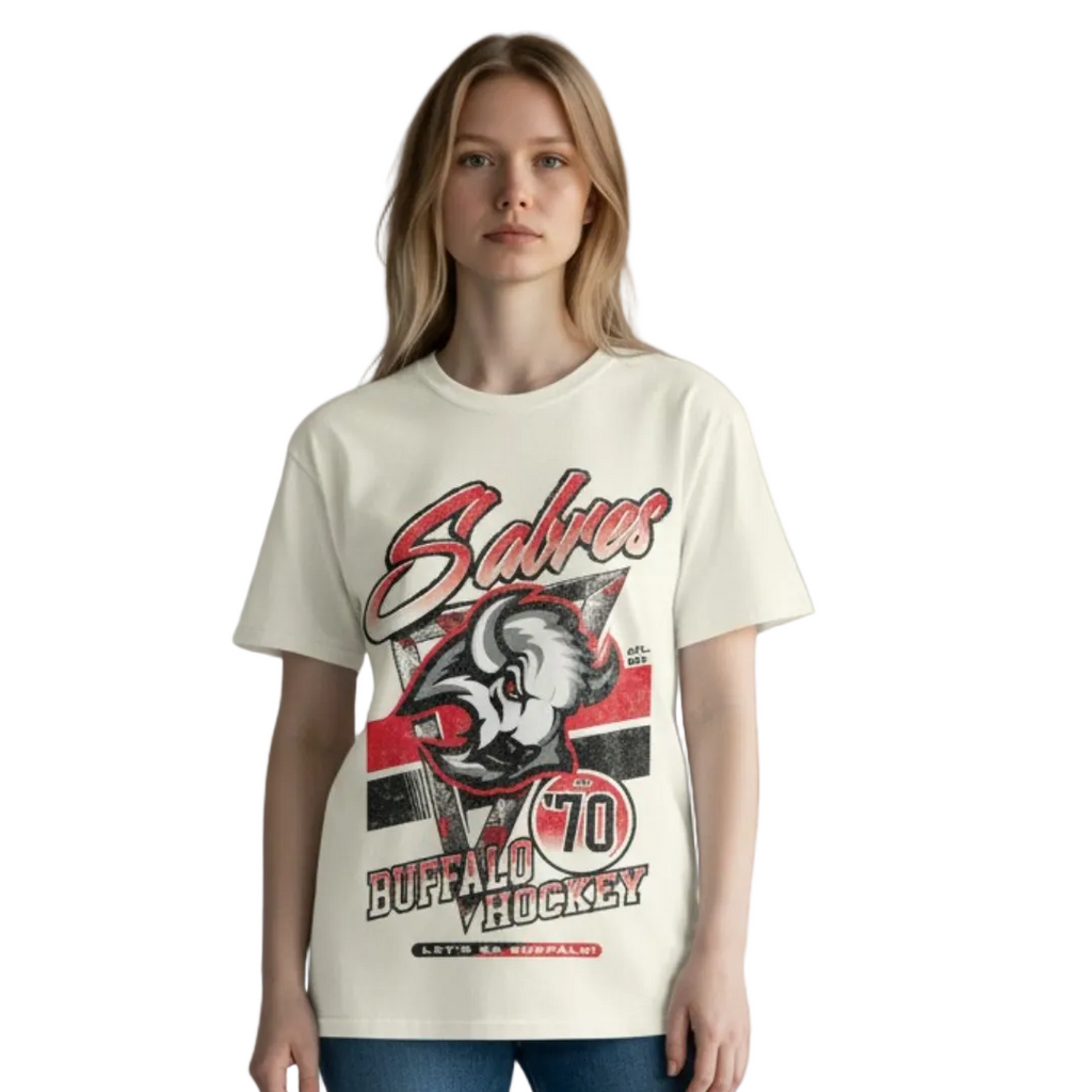 Person wearing a t-shirt with a graphic design on a plain background