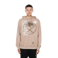 A man wearing a beige Sabres hockey hoodie with a large white and brown graphic on the front, standing against a plain white background.