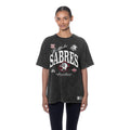 A woman modeling a dark washed charcoal gray Buffalo Sabres graphic t-shirt against a plain white background.