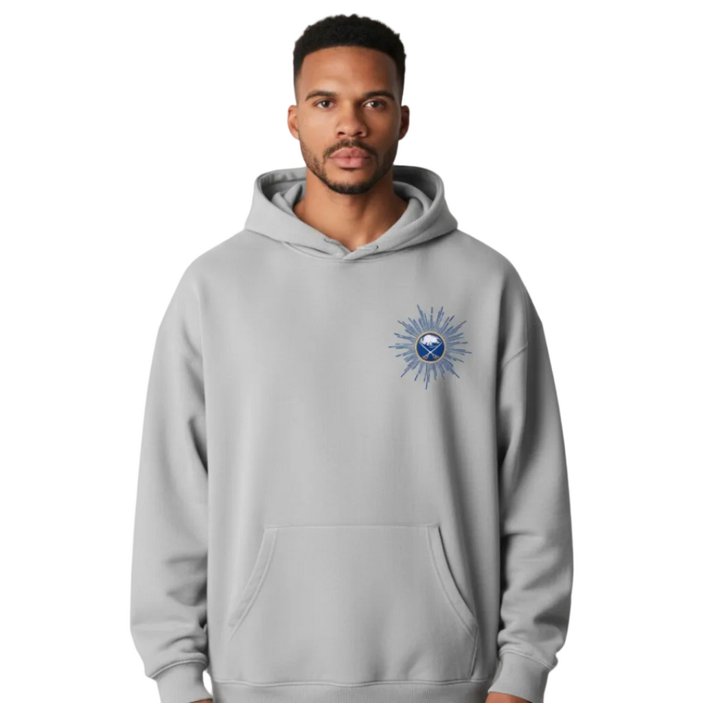 Man wearing a gray hoodie with a logo on a gray background
