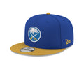 Blue and yellow baseball cap with a logo on a white background