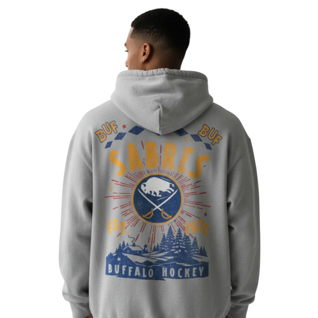 Person wearing a gray hoodie with a 'Sabres' logo on the back against a plain background