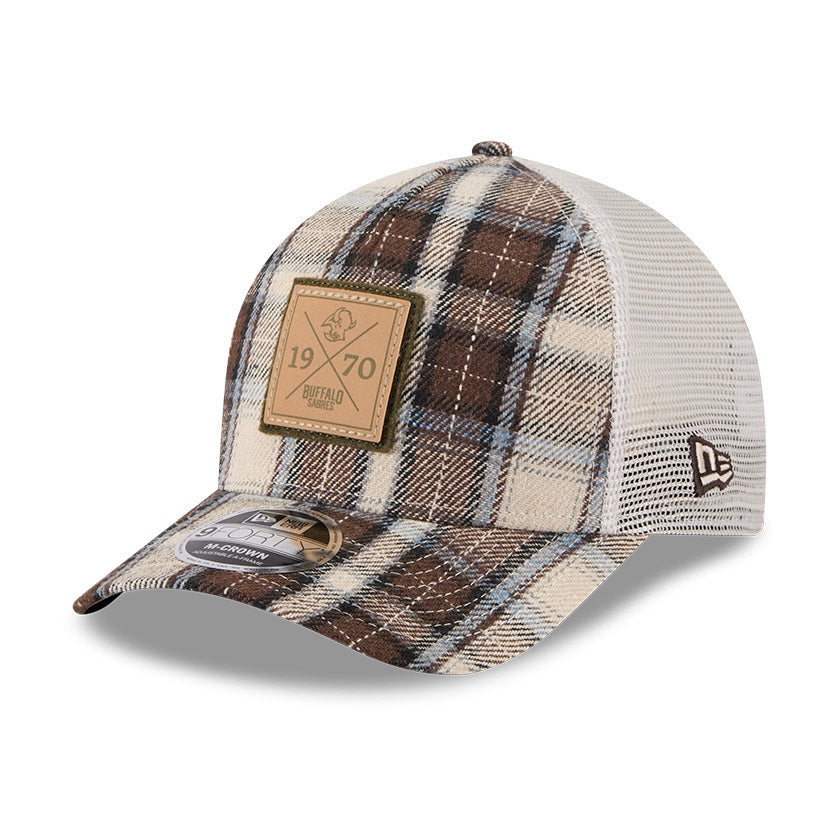 Plaid patterned cap with a brown patch on a white background