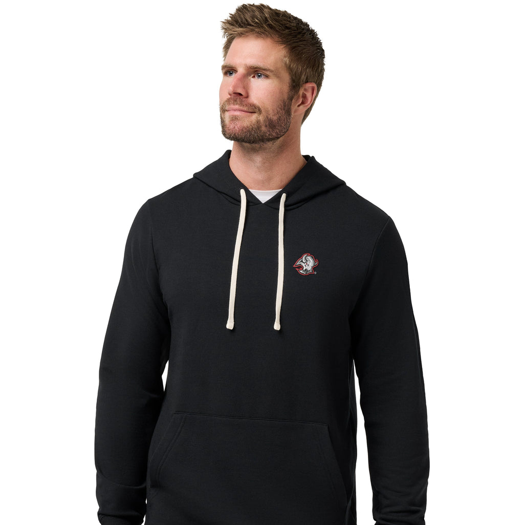 A man wearing a black pullover hoodie with cream drawstrings and a small embroidered logo on the left chest, paired with gray pants, against a plain white background.
