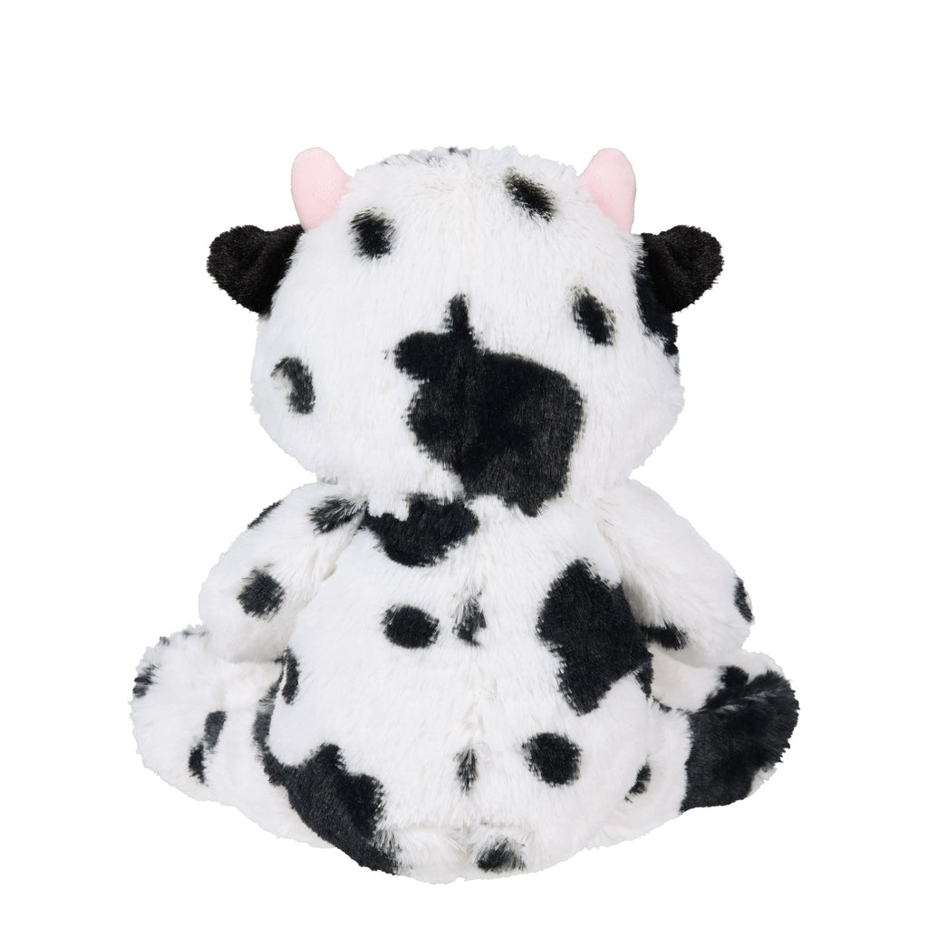 A plush cow toy shown from the back, featuring a white fuzzy body with black spots, black ears, and small pink ears, set against a plain white background.