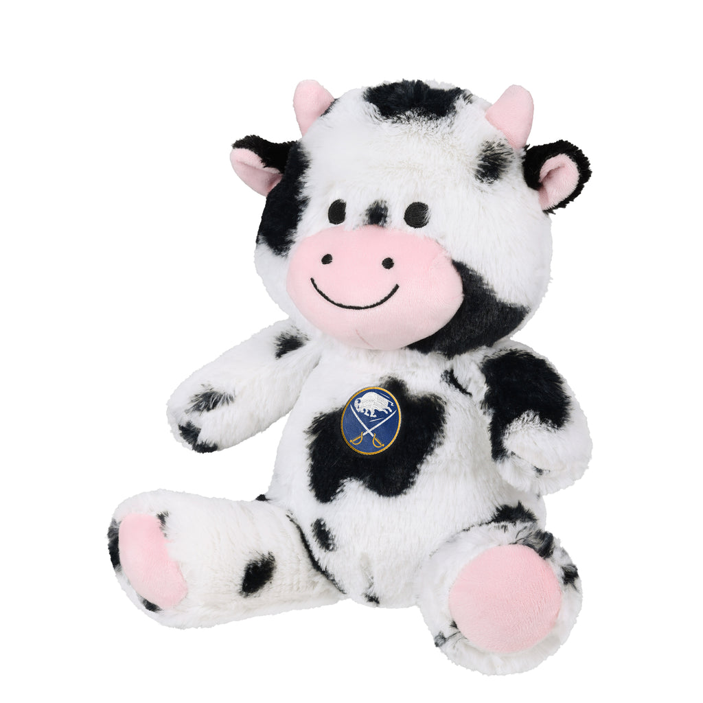 A plush toy cow with a black and white spotted pattern, pink snout and ears, and a circular Buffalo Sabins logo on its chest, photographed against a solid white background.