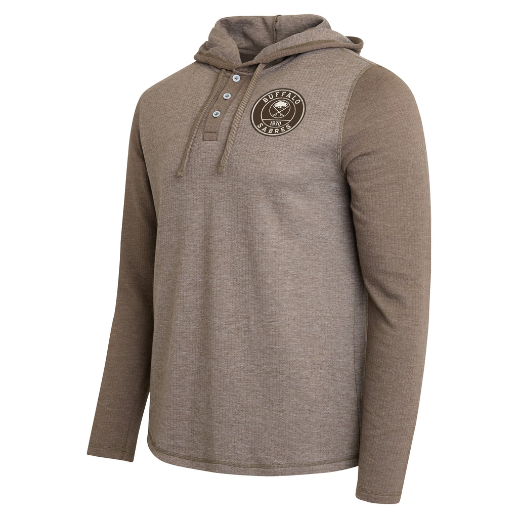 A men's long-sleeve pullover hoodie in heathered taupe brown, featuring a buttoned henley-style collar and a circular 'New Orleans Saints' logo patch on the left chest. The sleeves and hood are solid taupe, while the body is heathered taupe with a subtle textured knit pattern.