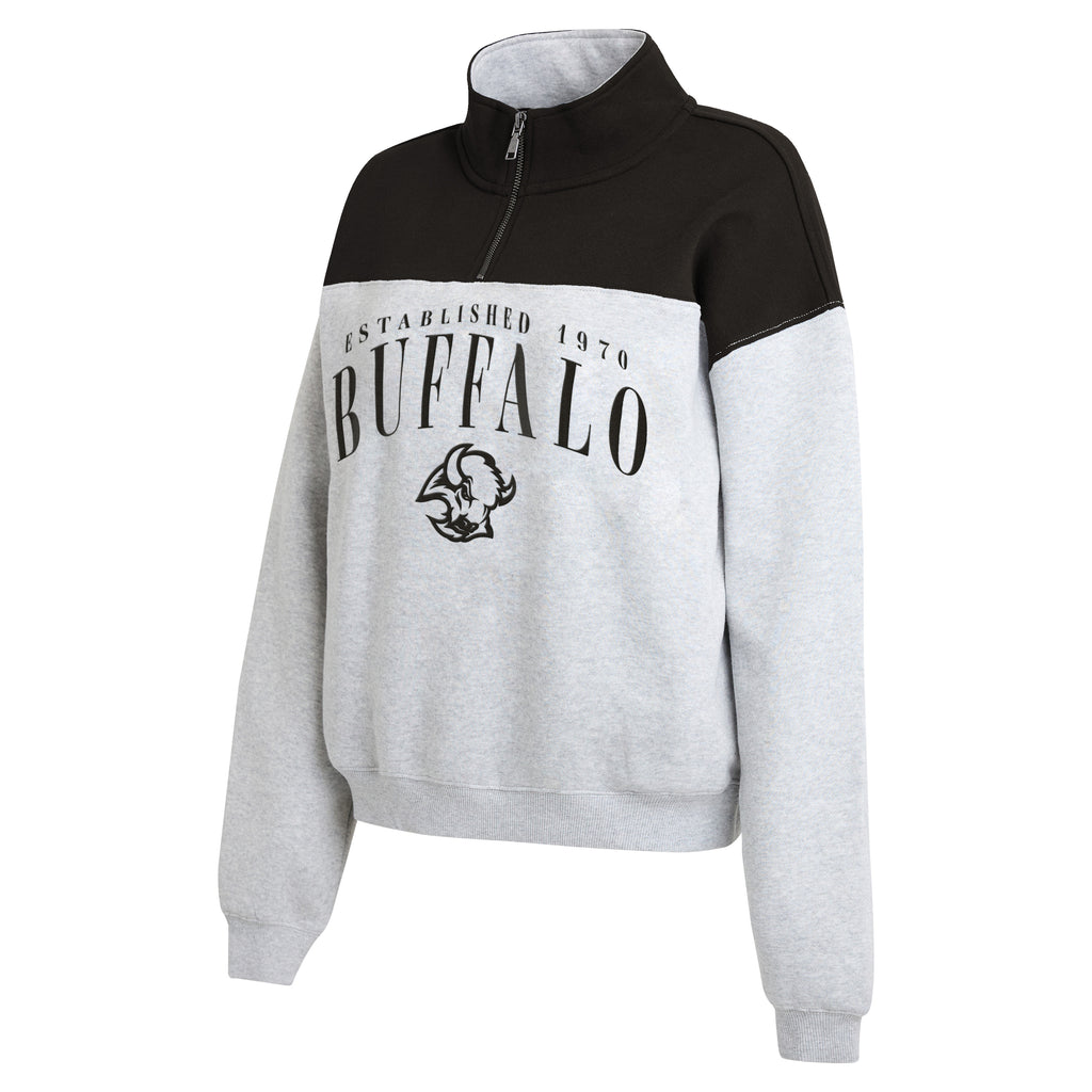 A women's colorblock quarter-zip sweatshirt featuring a black upper yoke and shoulders, light heather gray sleeves and lower body, with a black buffalo graphic and 'ESTABLISHED 1970 BUFFALO' text on the chest.