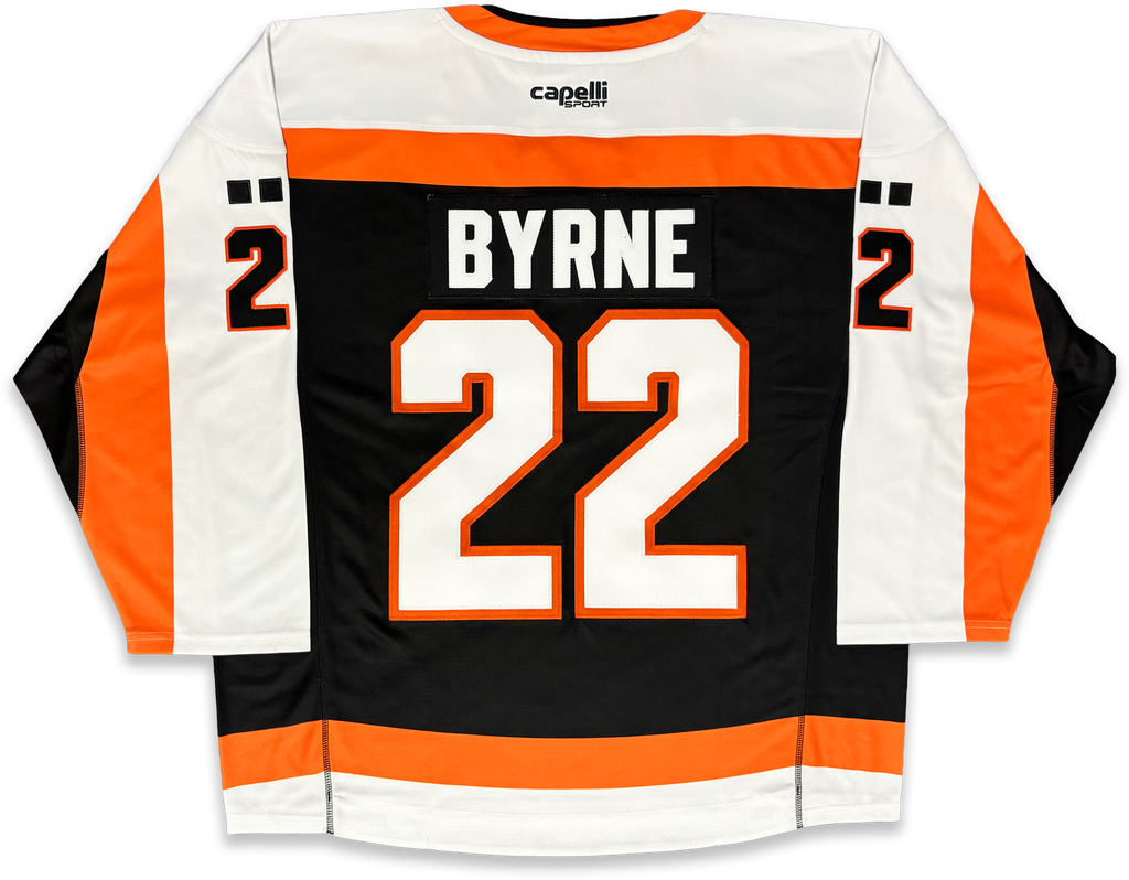 Back view of a lacrosse jersey with 'BYRNE' and the number '22' in white with orange outlines on a black background, with white sleeves and orange side panels. The capelli logo is visible at the collar.