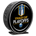 Hockey puck with Stanley Cup Playoffs branding on a white background
